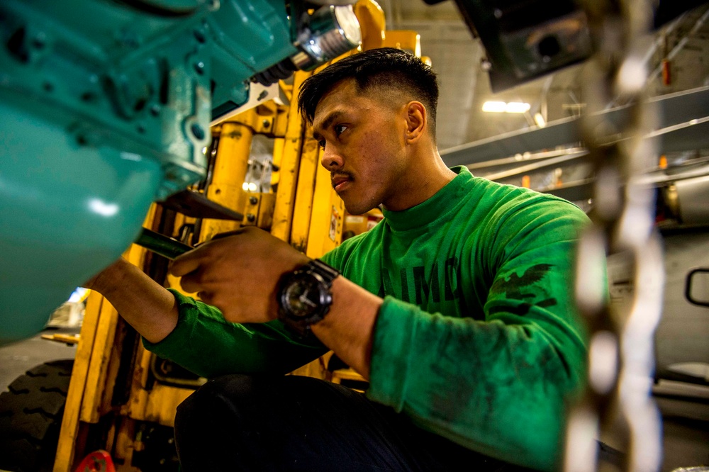 GHWB Sailor conducts maintenance on an engine