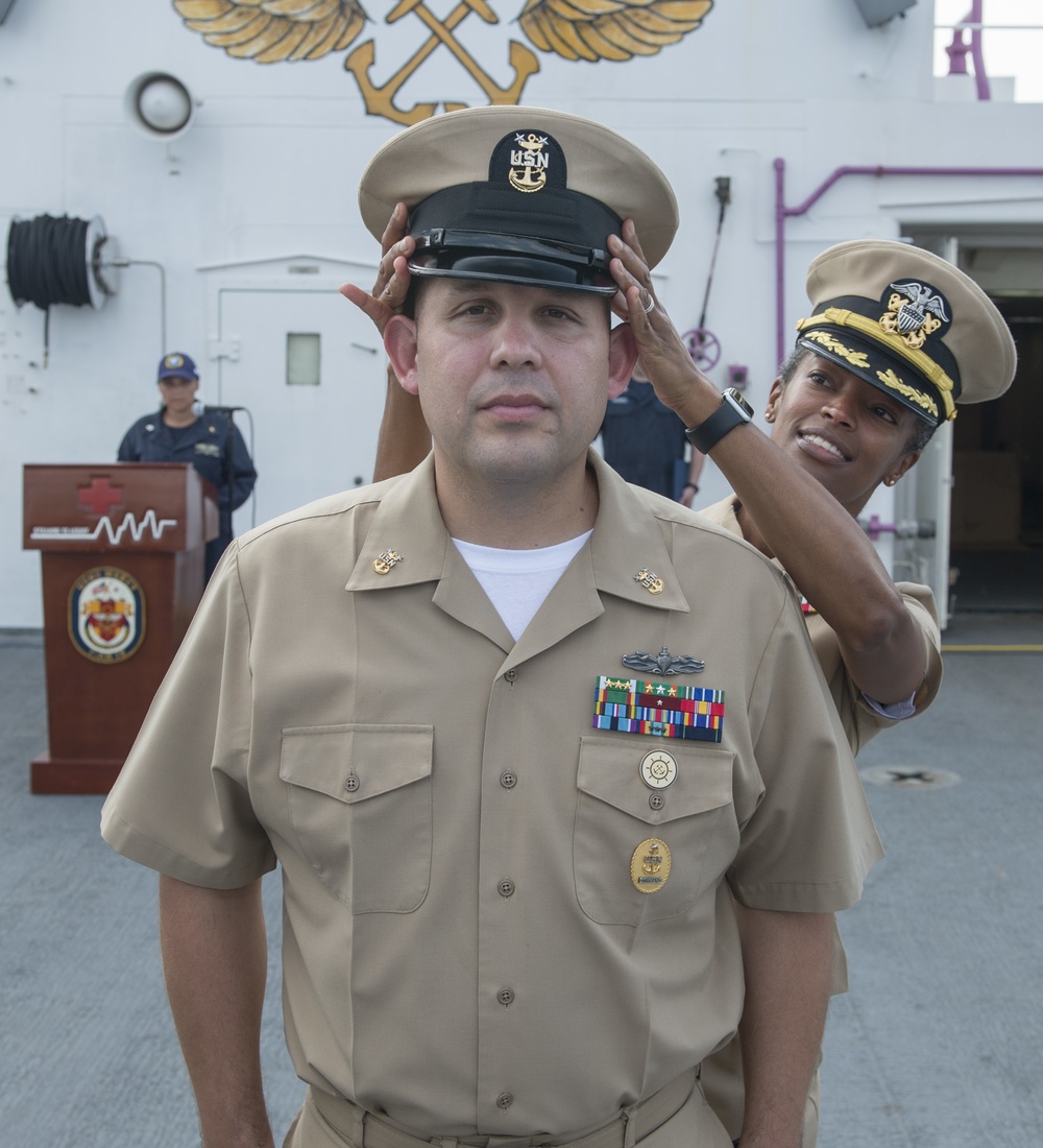 Service members aboard USNS Mercy particpate in a master chief petty officer promotion ceremony