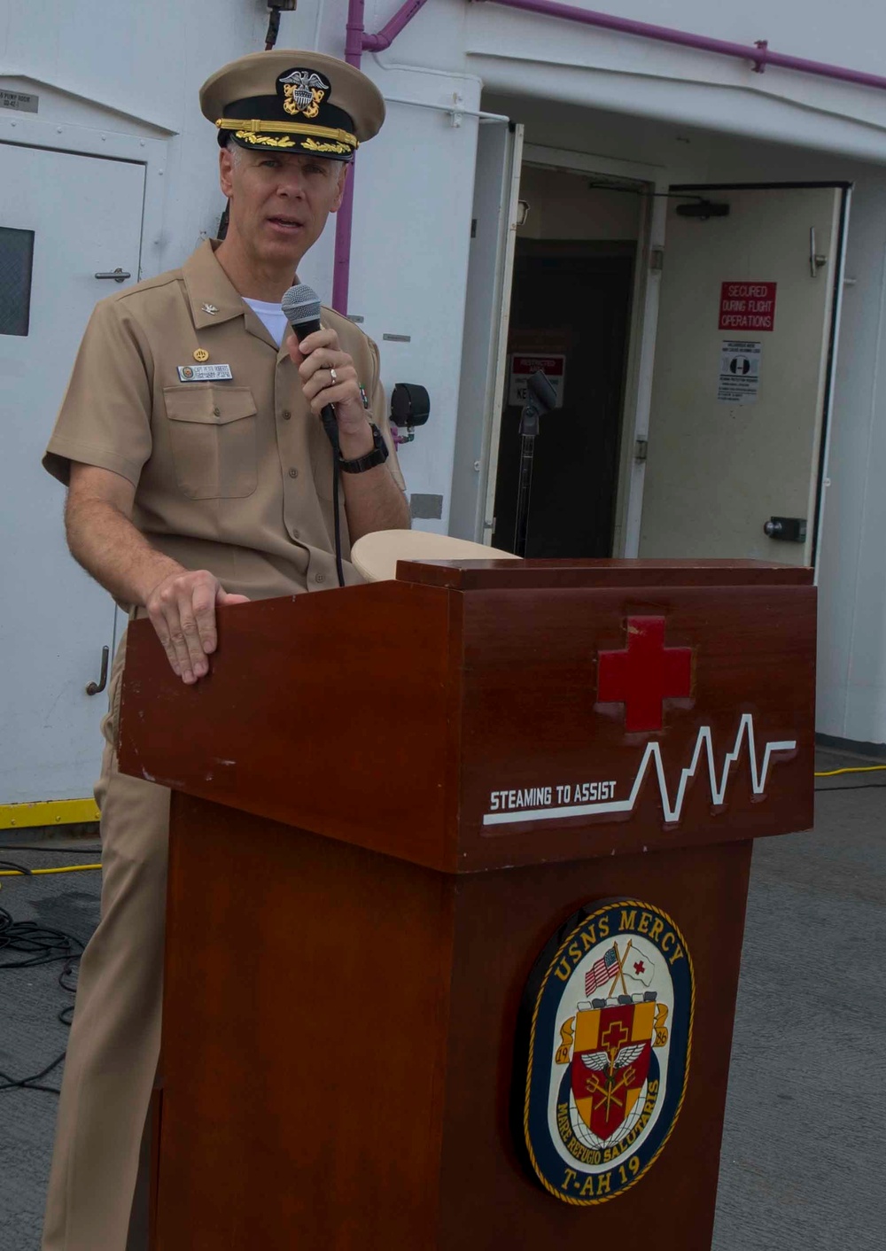 Service members participate in all-hands call aboard USNS Mercy