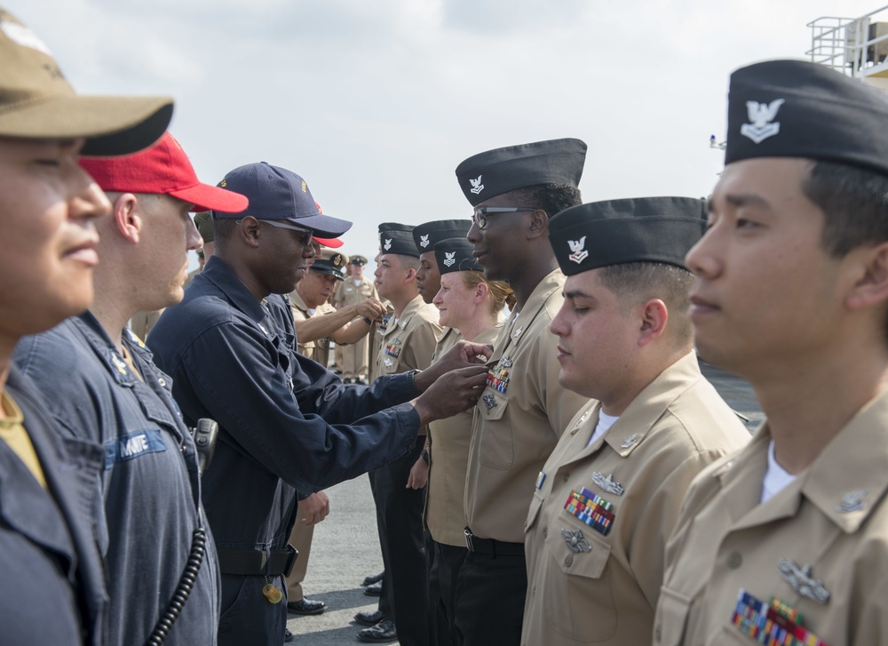 Service members aboard USNS Mercy particpate in a master chief petty officer promotion ceremony