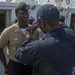 Service members participate in all-hands call aboard USNS Mercy