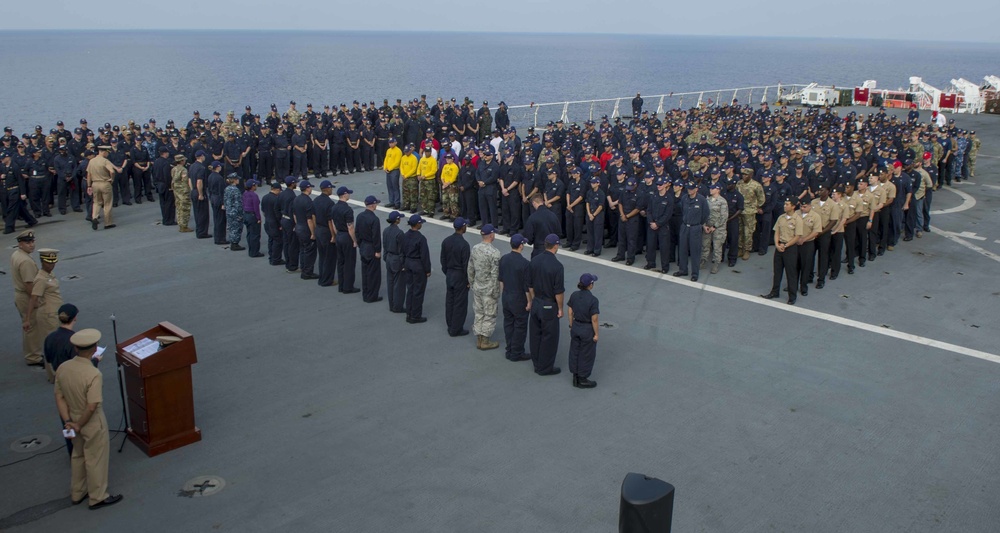 Service members participate in all-hands call aboard USNS Mercy