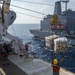 Service members and civilian mariners conduct a replenishment-at-sea aboard USNS Mercy