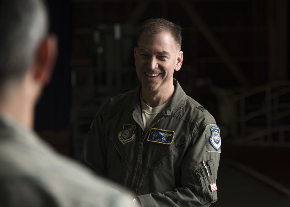 The general laughs with Airmen