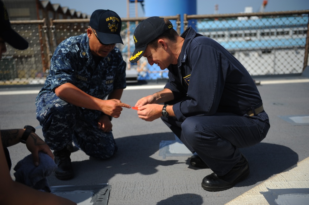 Blue Ridge Sailors preserve the flight deck.