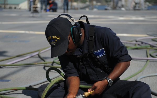 Blue Ridge Sailors preserve the flight deck.