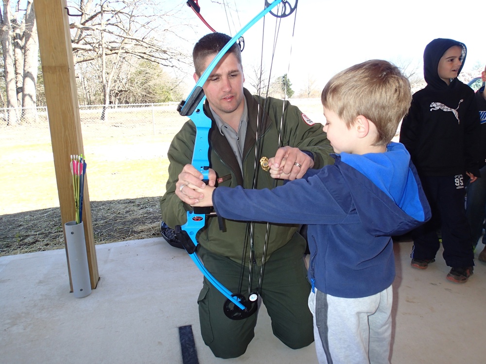 Park ranger assists at archery range