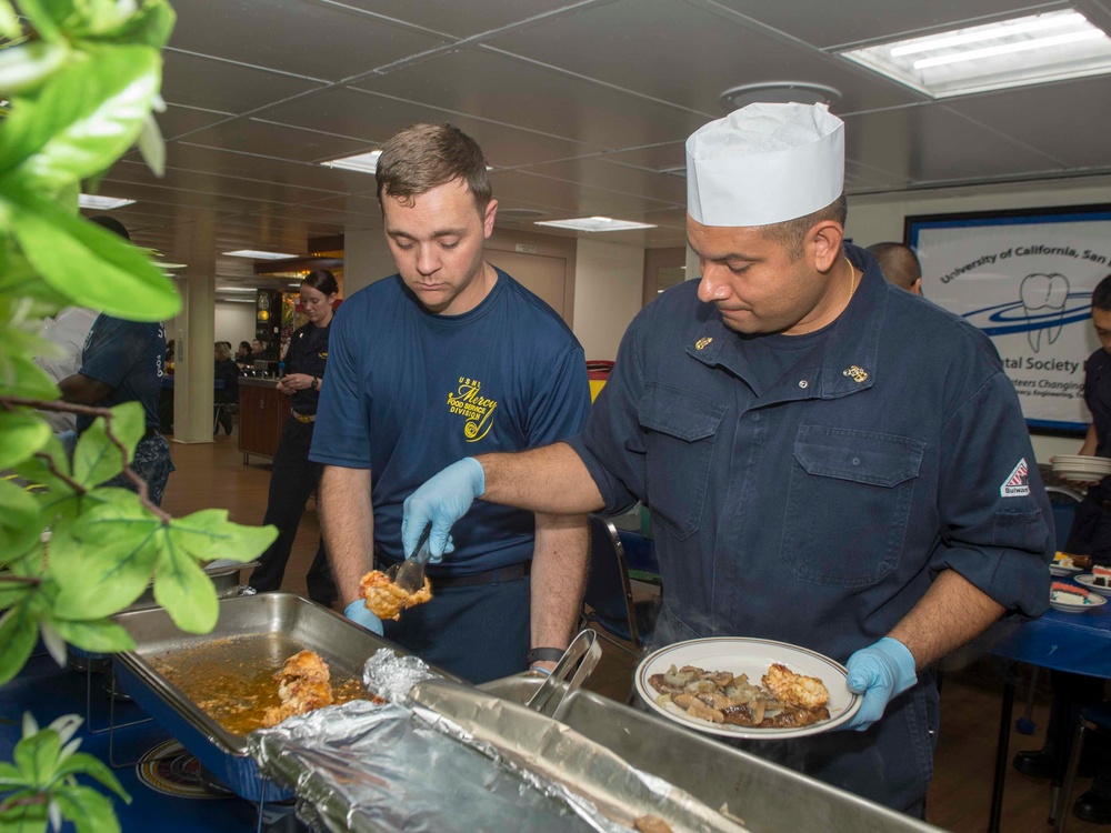 Service members celebrate people aboard USNS Mercy born in May