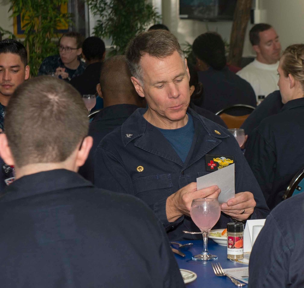 Service members celebrate people aboard USNS Mercy born in May