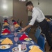 Service members celebrate people aboard USNS Mercy born in May