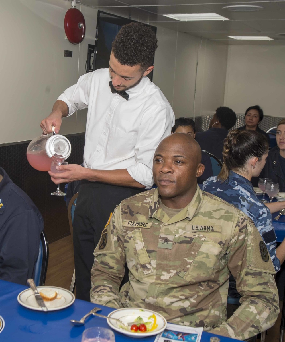 Service members celebrate people aboard USNS Mercy born in May