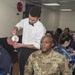 Service members celebrate people aboard USNS Mercy born in May