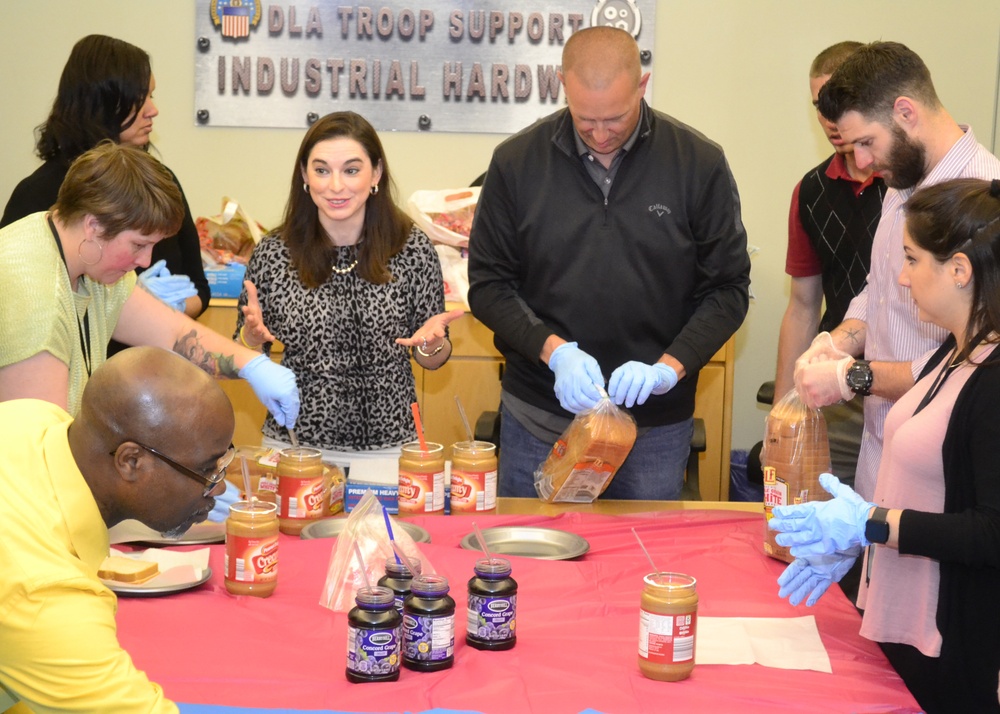 Mentors and mentees join together to make sandwiches as part of &quot;blessing bags&quot; for the homeless in Philadelphia on May 17.