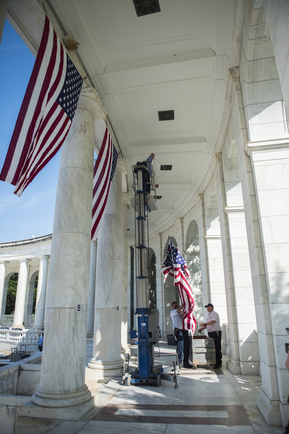 Arlington National Cemetery Employees Hang American Flags in the Memorial Amphitheater