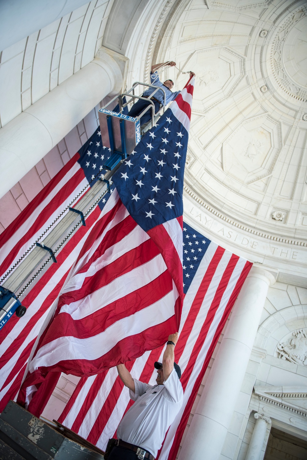 Arlington National Cemetery Employees Hang American Flags in the Memorial Amphitheater