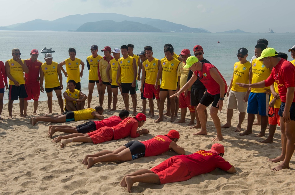 PP18 servicemembers join Vietnamese swimmers in a surf lifesaving event.