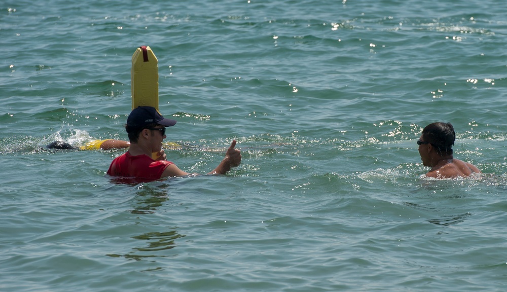 PP18 servicemembers join Vietnamese swimmers in a surf lifesaving event.