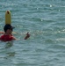 PP18 servicemembers join Vietnamese swimmers in a surf lifesaving event.