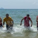 PP18 servicemembers join Vietnamese swimmers in a surf lifesaving event.