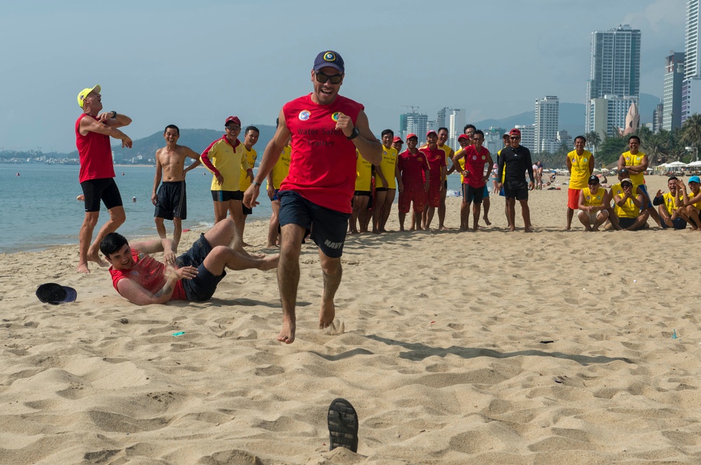PP18 servicemembers join Vietnamese swimmers in a surf lifesaving event.