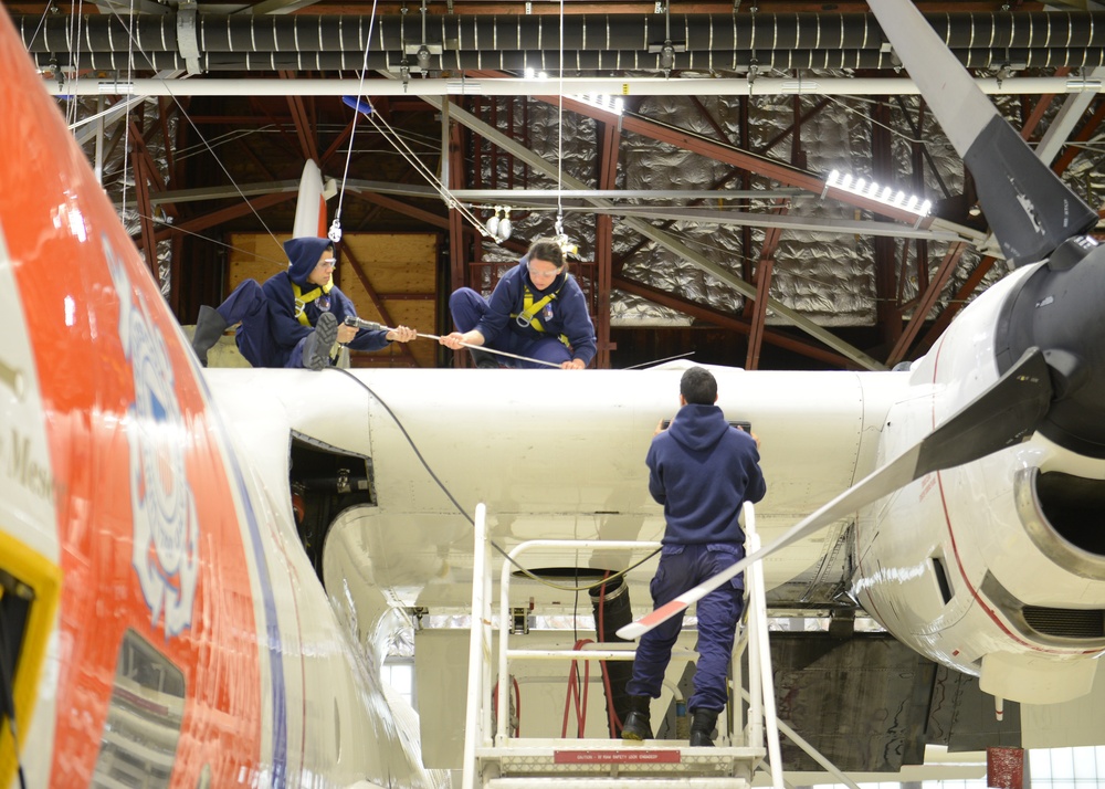 Coast Guard aviation personnel maintain C-130 aircraft