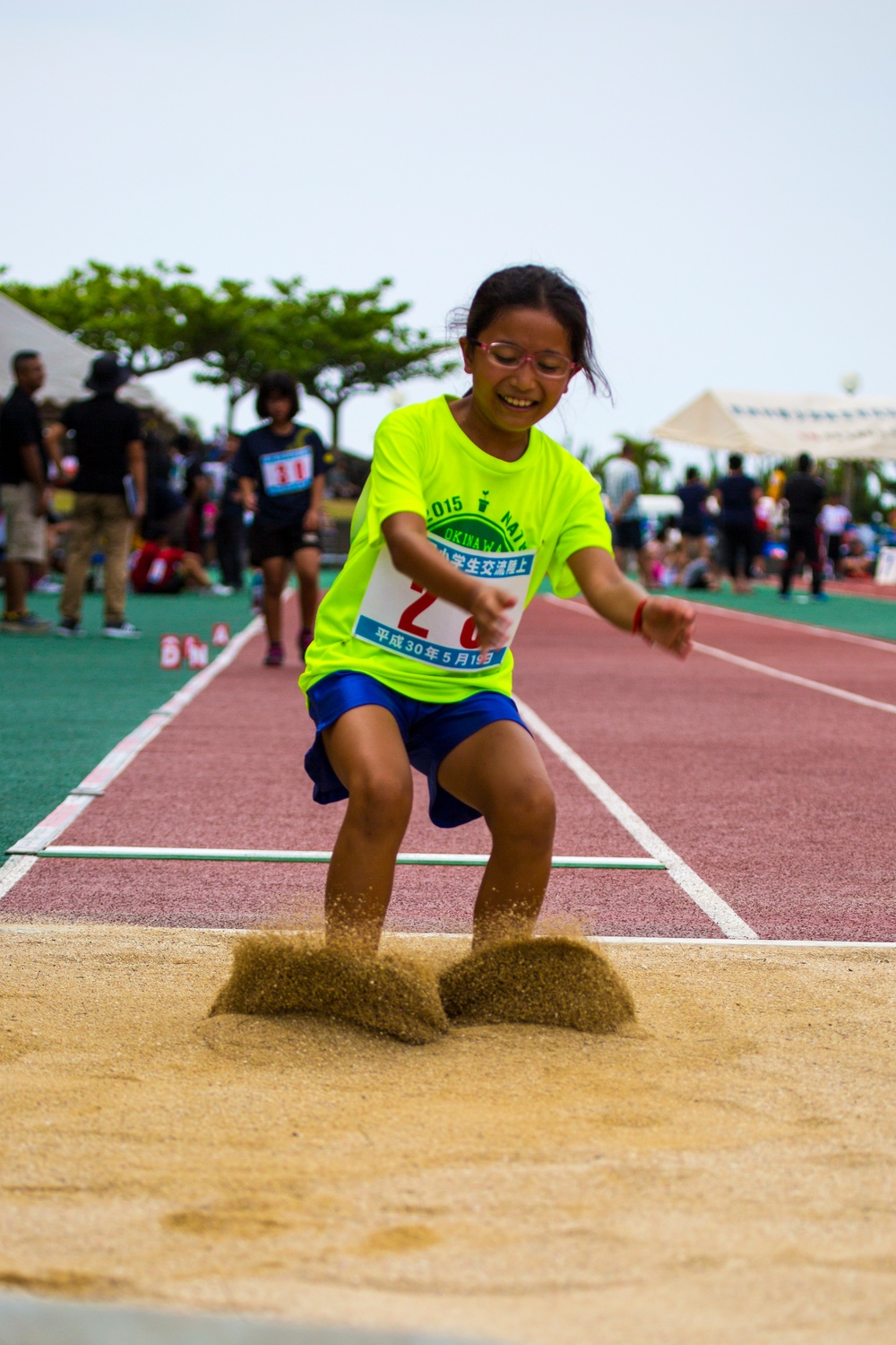 Children from the local and US communities compete in track meet
