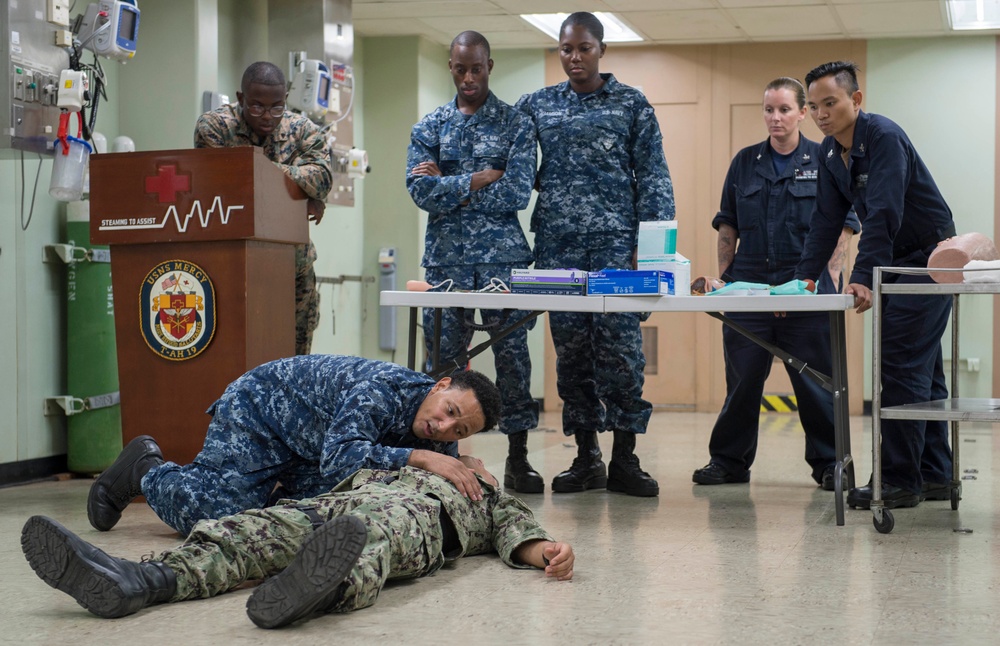 Service members participate in TCCC aboard USNS Mercy