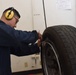 Apprentice changes tire