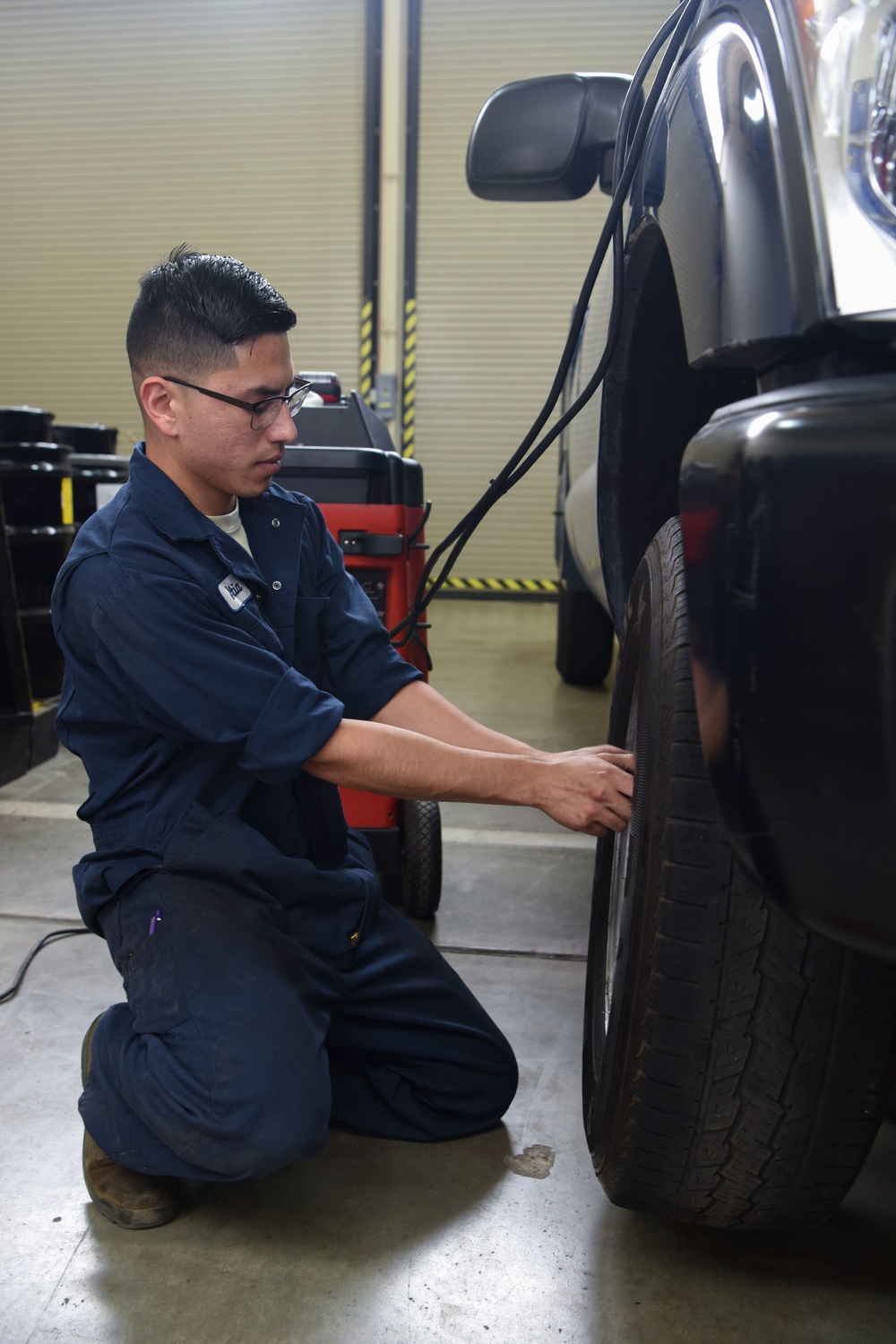 Apprentice changes tire