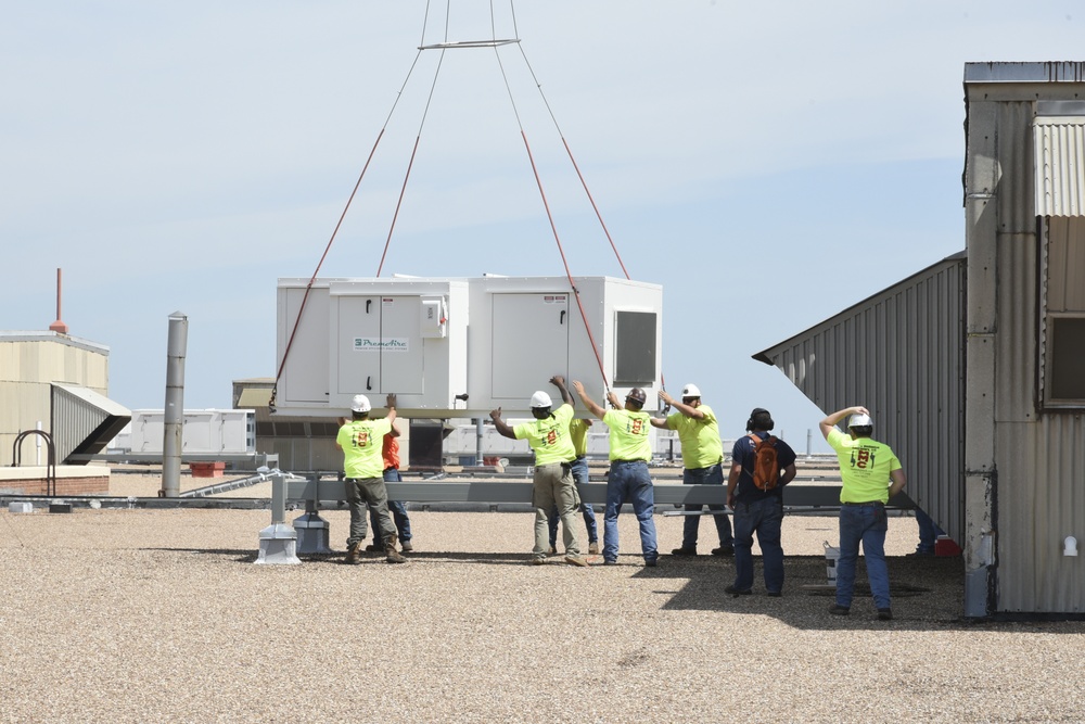 Helicopter moves 57 air conditioning units to roof of Bldg 3001.