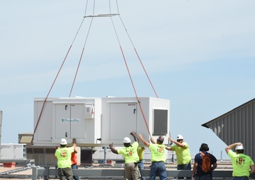 Helicopter moves 57 air conditioning units to roof of Bldg 3001.