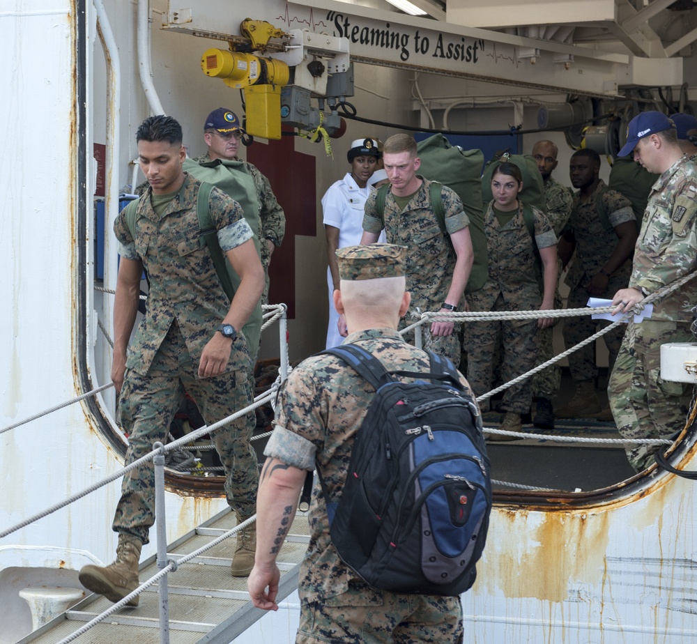 Service Members disembark USNS Mercy in Okinawa