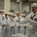 USS America Sailor conducts band during ceremony