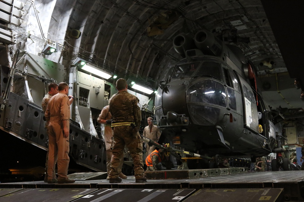 Royal Air Force crew members prepare Puma for transport