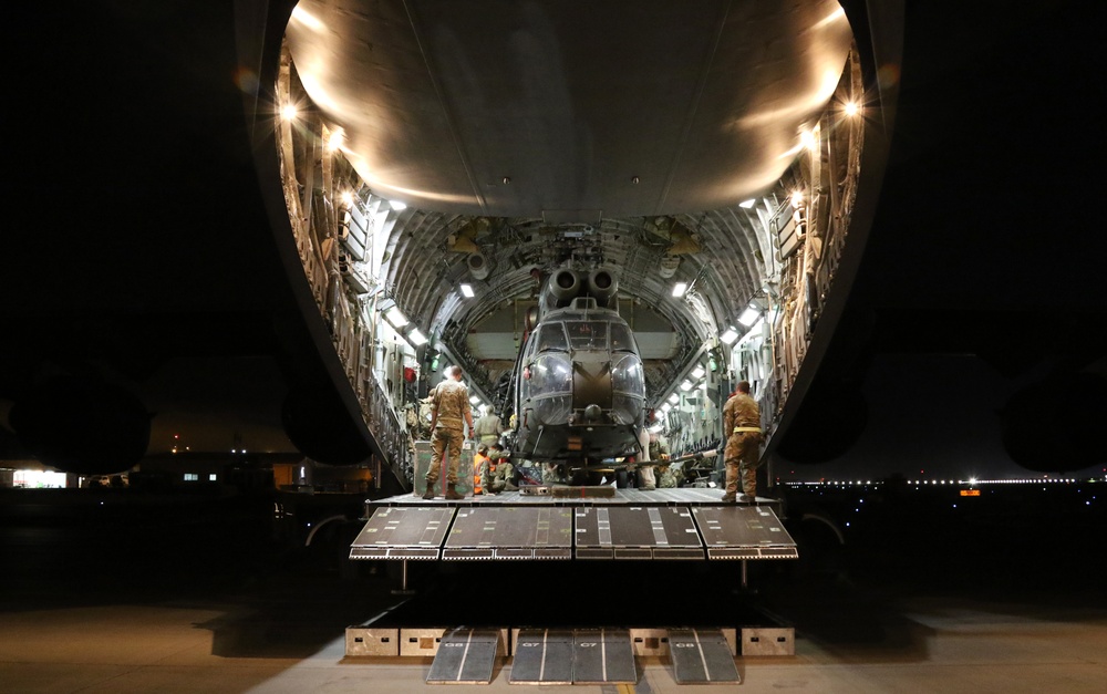 Royal Air Force crew members prepare Puma for transport