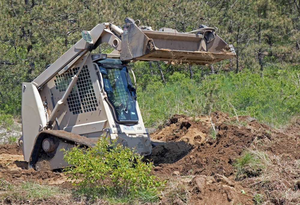 Soldier uses agile machinery to help clear hard to reach areas of dig site