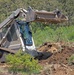 Soldier uses agile machinery to help clear hard to reach areas of dig site