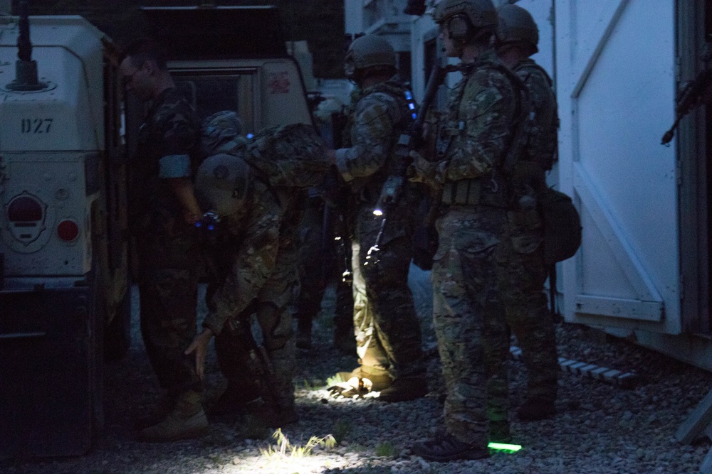 Soldiers search and secure a captured combatant during Combined Arms Exercise