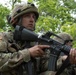 Soldiers search woods for hostile forces during Combined Arms Exercise