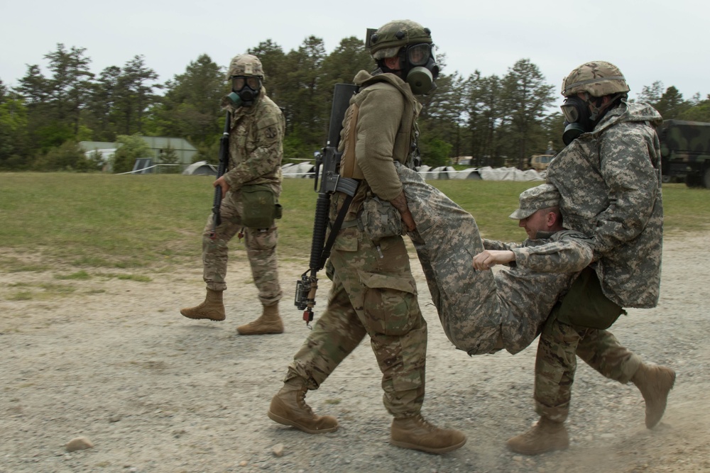 Soldiers carry an injured soldier to safety during a training exercise at Joint Base Cape Cod