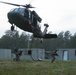 Soldiers descend from Blackhawk during Combined Arms Exercise
