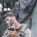 U.S. soldier applies camouflage during Saber Strike 18