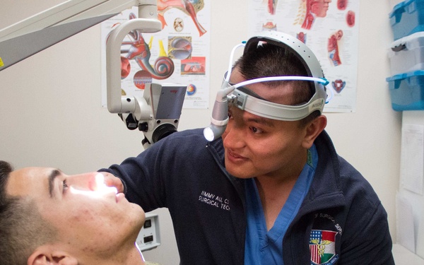 HM2 Au Performs ENT Exam