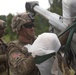 Crew member prepares howitzer for air drop