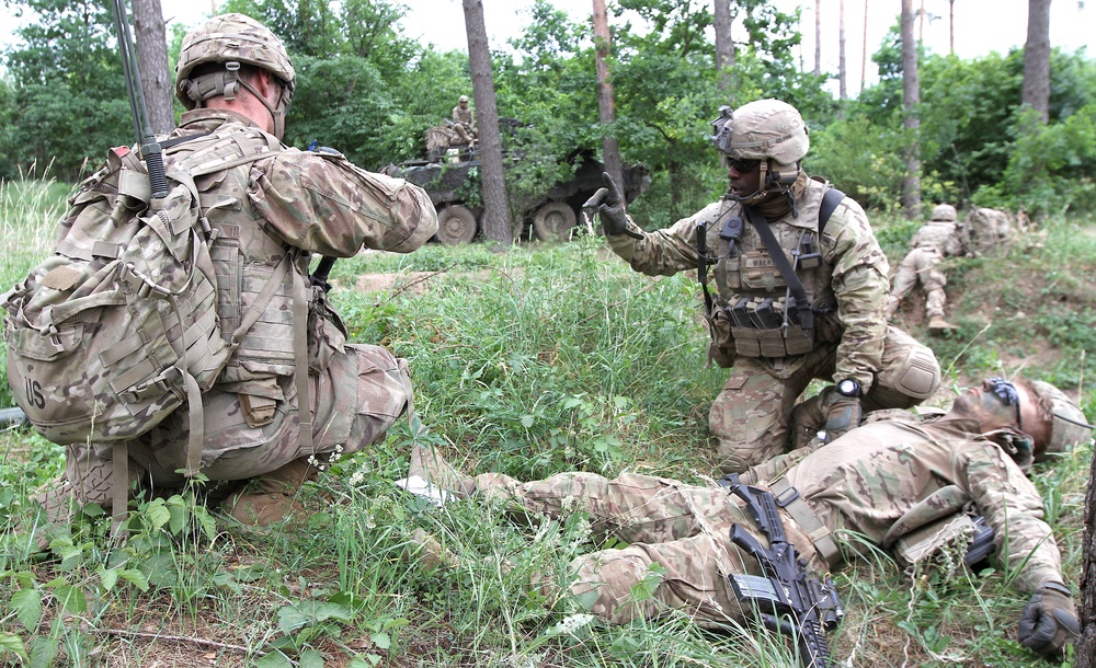 U.S. Army soldier provides aid to simulated injured soldier