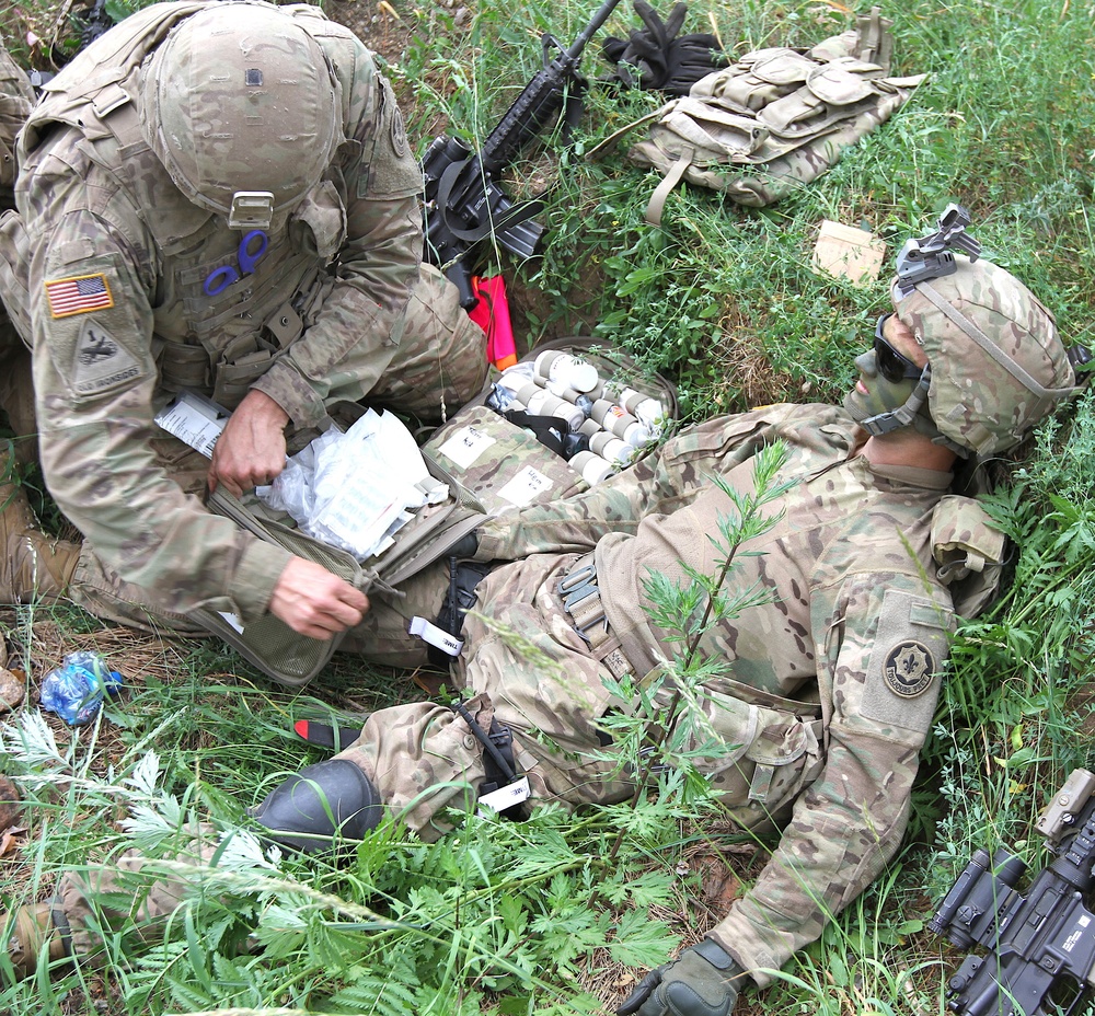 U.S. Army medic provides aid to simulated injury during Saber Strike 18