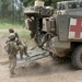 U.S. Army soldier loads simulated injured soldier into Medical Evacuation Vehicle