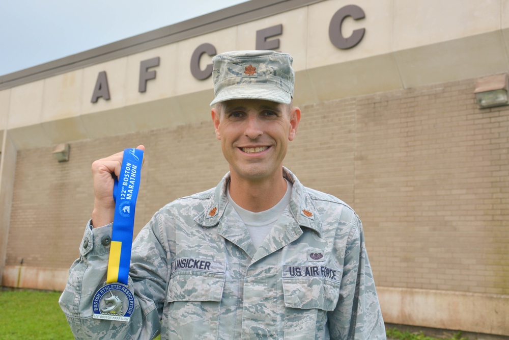 Major Andy Unsicker, ULFSC Chief, AFCEC, displays Boston Marathon medal