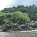 Strykers are ferried across the Neman River