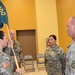 Capt. Erin Montoya, outgoing commander of the 200th Public Affairs Detachment, 93rd Troop Command, New Mexico Army National Guard, prepares to hand over the unit colors to Col. Michael A. Treadwell.